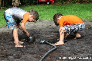 Boys dig in mud