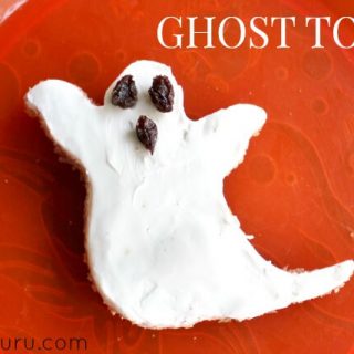 Ghost Toast, cream cheese on ghost shaped toast with raisins for the eyes and mouth